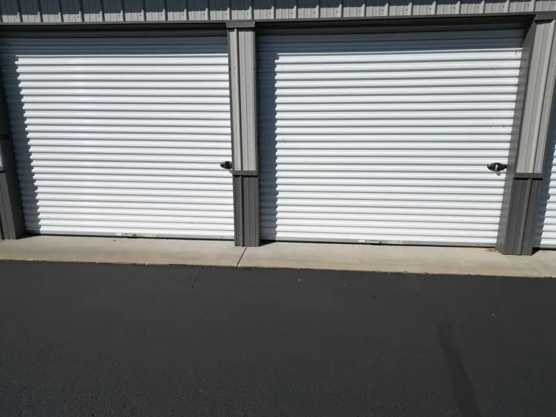Two adjacent storage unit doors, numbers 106 and 107, with latches ready for your own lock