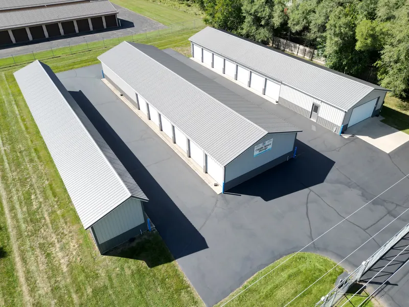 Aerial view of the whole Create Space Self Storage facility — three storage buildings around freshly paved drive aisles