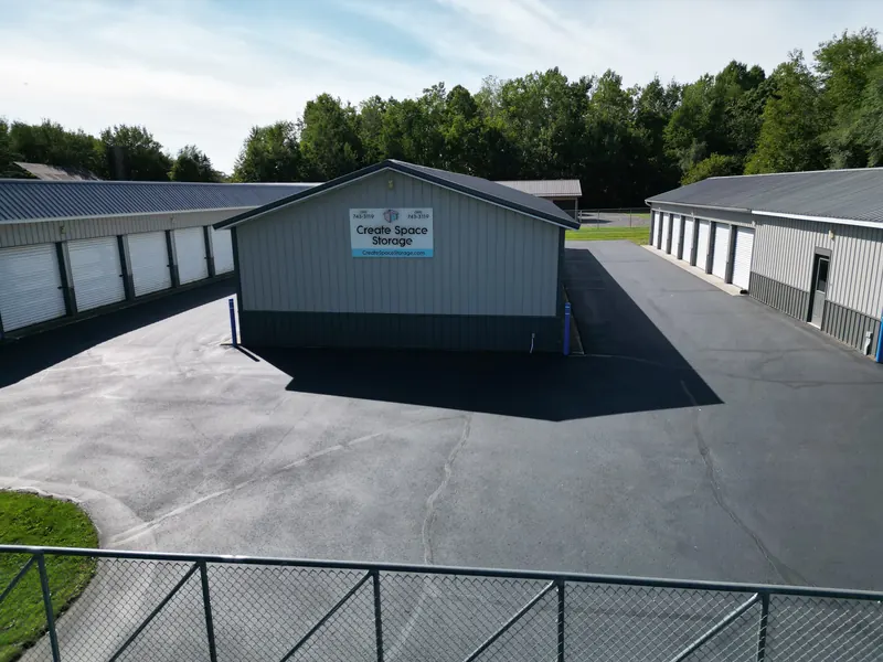 Looking into the storage facility courtyard from the entry gate, with unit rows on both sides