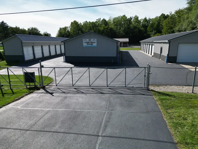 The chain-link security gate closed across the entrance drive at Create Space Self Storage