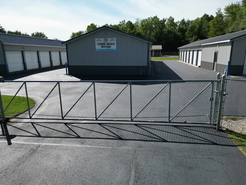Perimeter chain-link fencing and the sliding entry gate at the storage facility