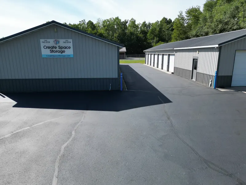 The Create Space Self Storage sign on the gable end of a building beside an open drive aisle